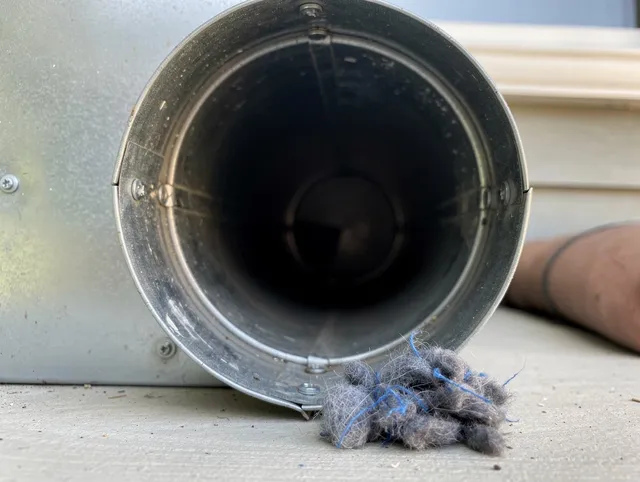 Long Beach Dryer Vent Cleaning technician using specialized equipment to clear severe dryer vent blockage in Long Beach